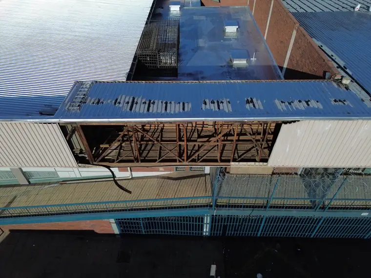 Roof section stripped back to exposed timber and steel trusses with new sheets ready